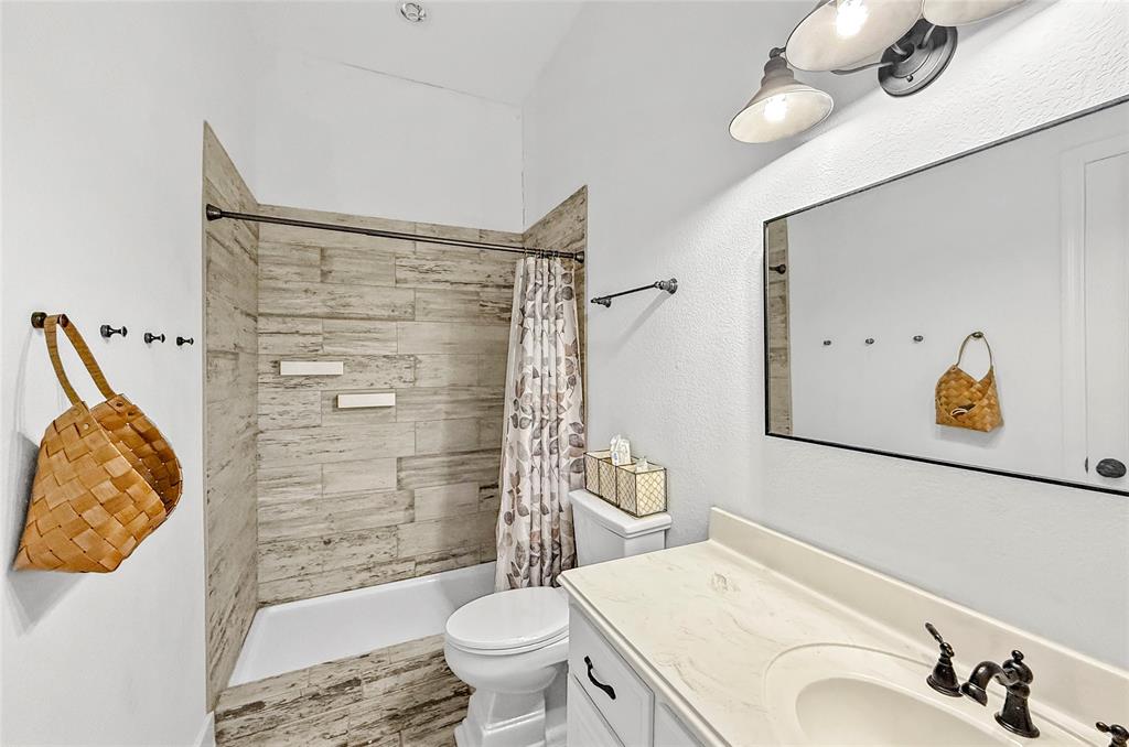 396 Ranchview Court Bowie, TX 76230 - Photo 22 of 40 a bathroom with a sink toilet and shower