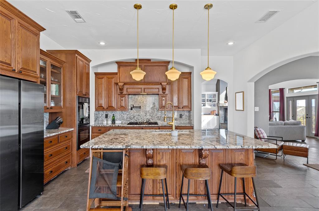 396 Ranchview Court Bowie, TX 76230 - Photo 7 of 40 a large kitchen with a table and chairs