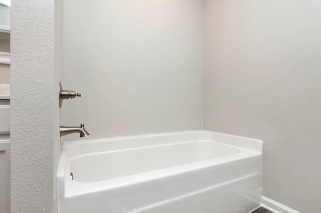 a white bath tub and shower