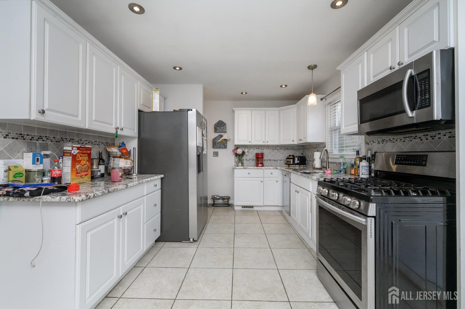 384 Cook Road Jackson, NJ 08527 - Photo 9 of 31 a kitchen with stainless steel appliances granite countertop a stove top oven a refrigerator a sink and dishwasher