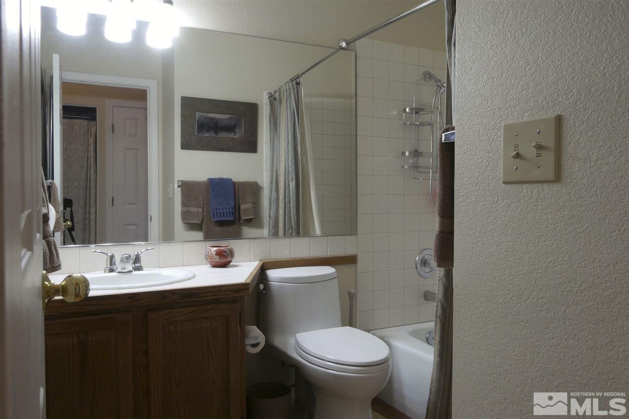 3288 Alum Creek Court Reno, NV 89509 - Photo 12 of 20 a bathroom with a sink toilet and shower