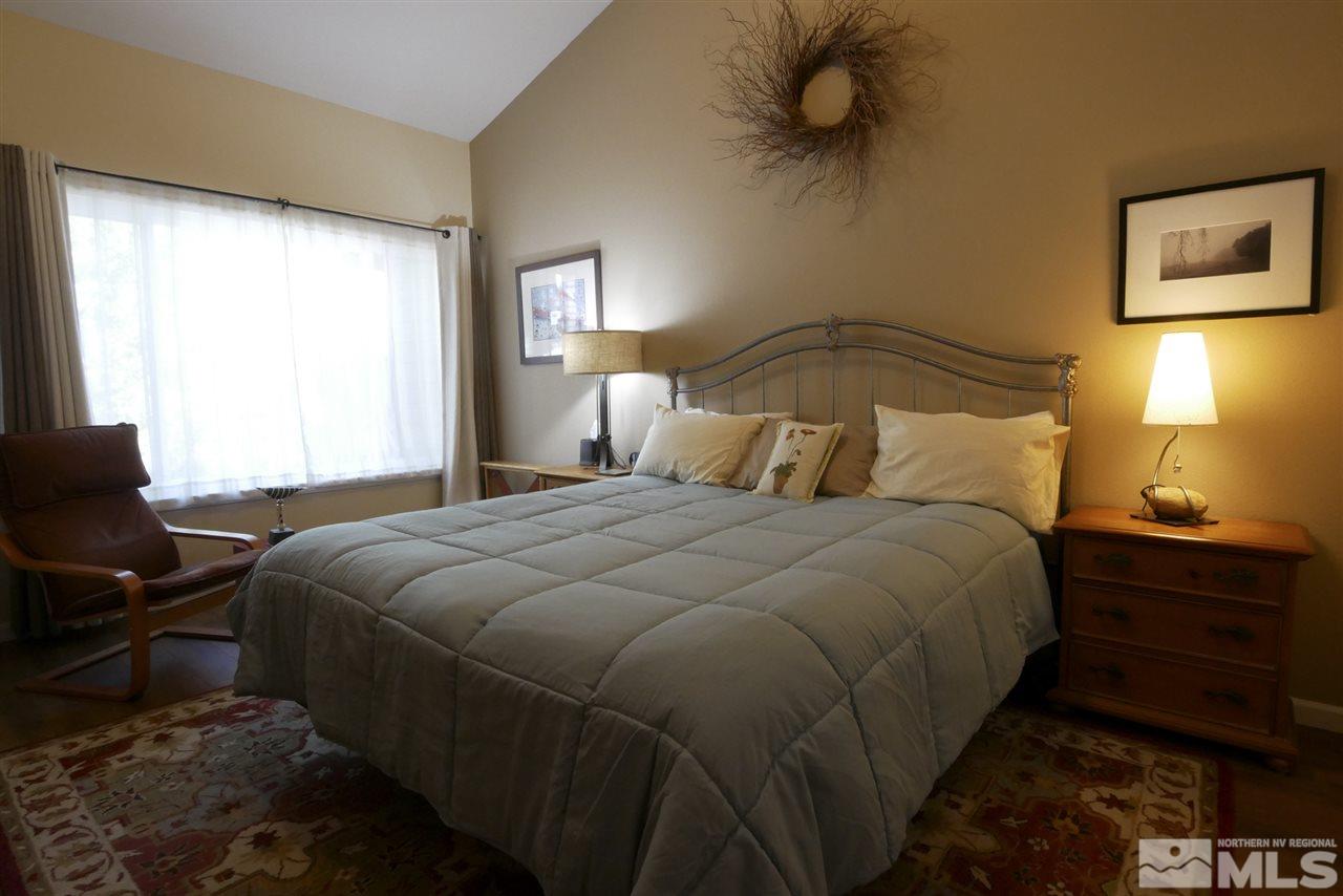3288 Alum Creek Court Reno, NV 89509 - Photo 13 of 20 a bedroom with a bed and wooden floor