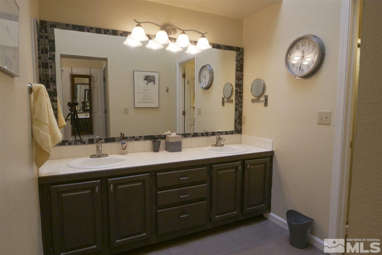 3288 Alum Creek Court Reno, NV 89509 - Photo 14 of 20 a bathroom with a double vanity sink and a mirror