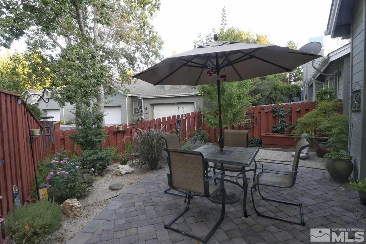 3288 Alum Creek Court Reno, NV 89509 - Photo 15 of 20 a view of backyard with seating space and trees
