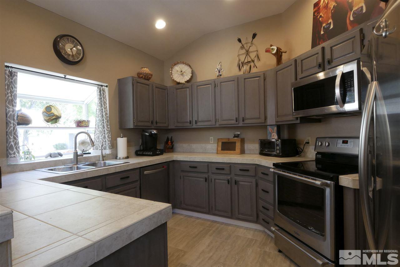 3288 Alum Creek Court Reno, NV 89509 - Photo 2 of 20 a kitchen with stainless steel appliances a stove sink microwave and cabinets