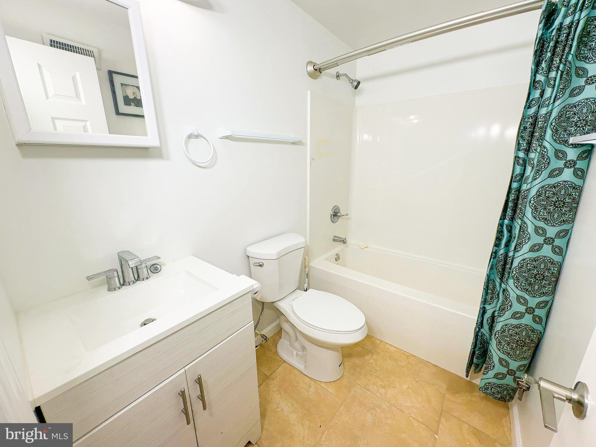 7403 Hawthorne Street Landover, MD 20785 - Photo 23 of 39 a bathroom with a sink toilet and shower