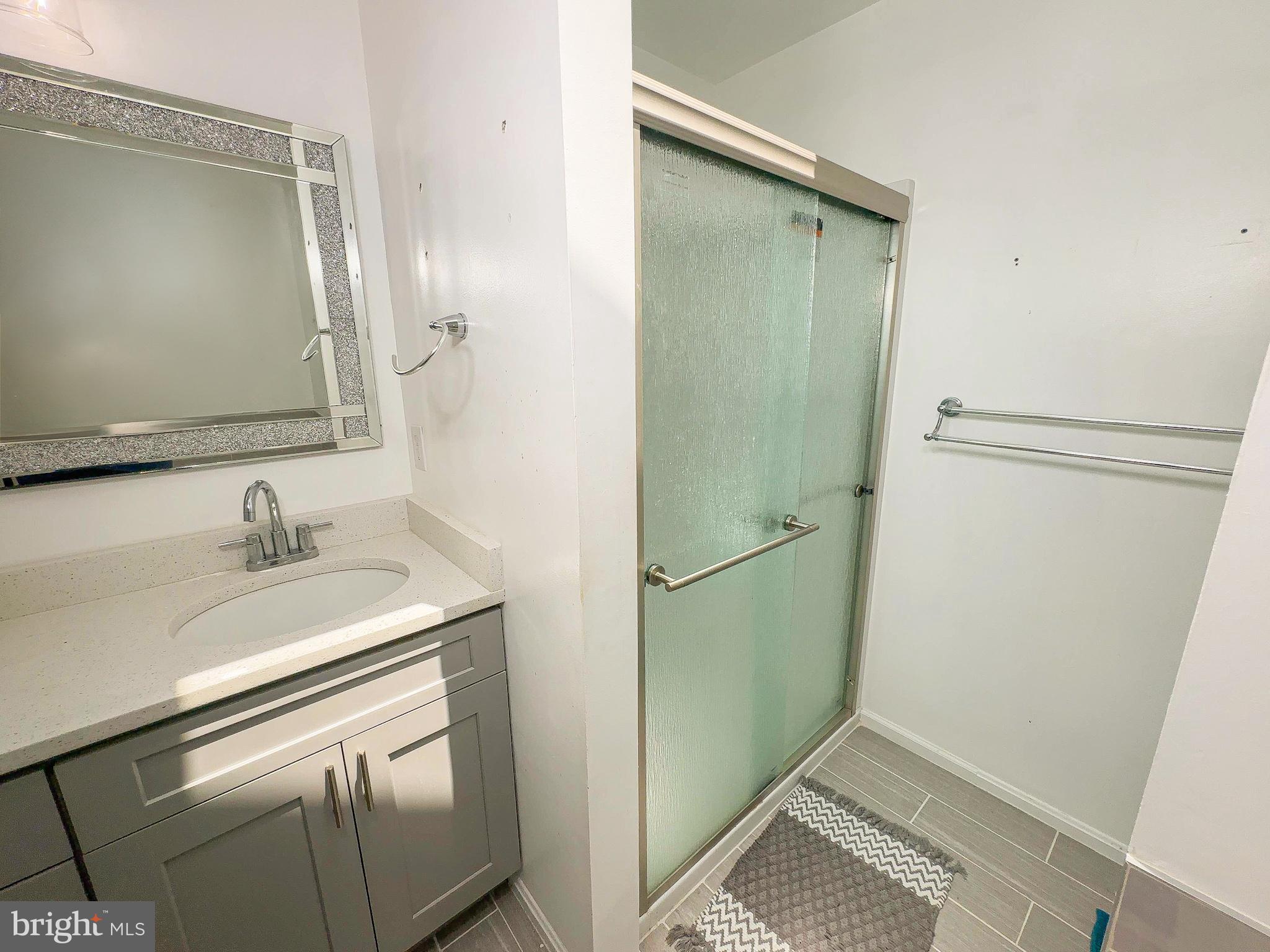 7403 Hawthorne Street Landover, MD 20785 - Photo 36 of 39 a bathroom with a sink and a mirror