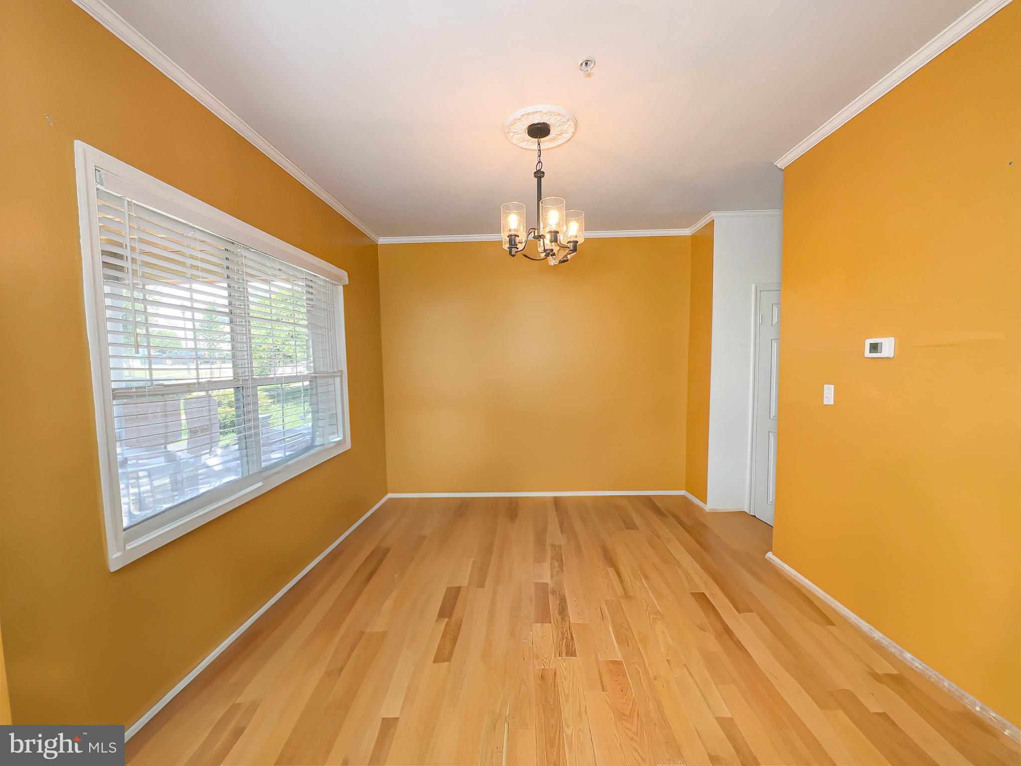 7403 Hawthorne Street Landover, MD 20785 - Photo 9 of 39 a view of empty room with wooden floor and fan