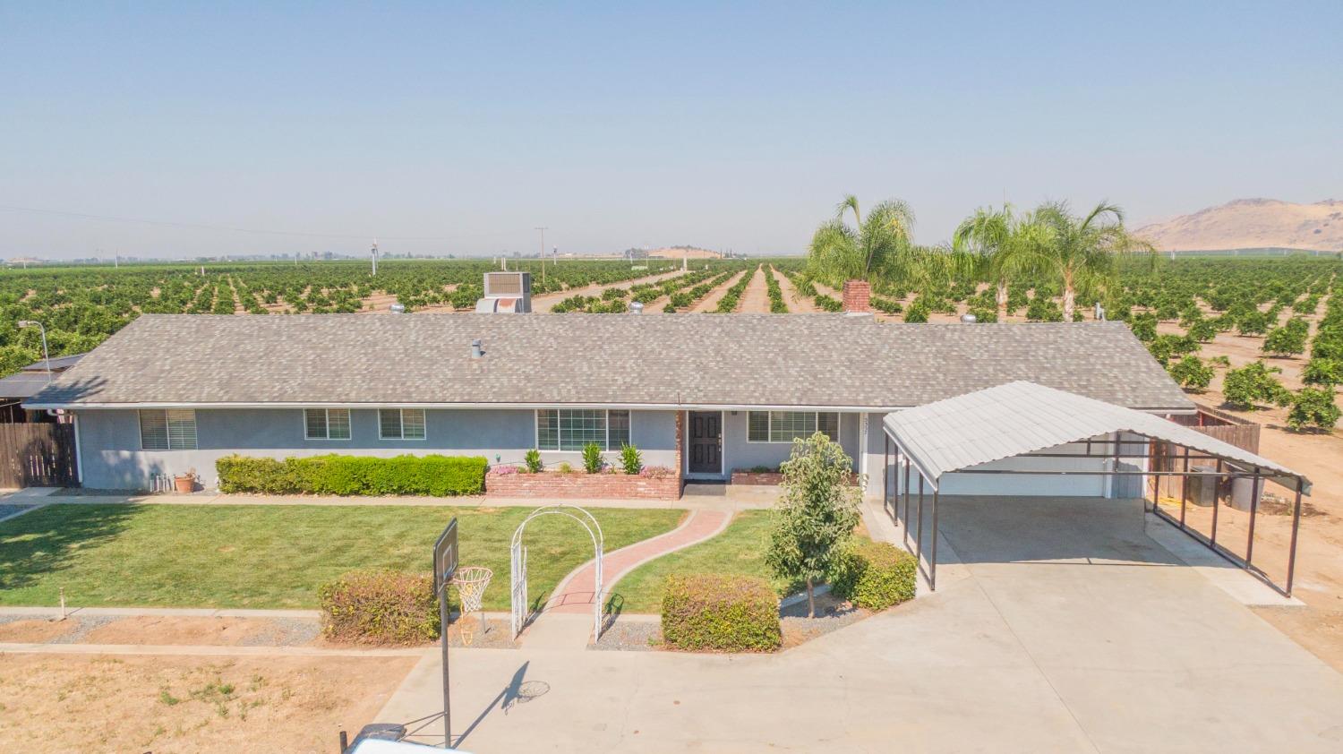 an aerial view of a house with a garden and lake view