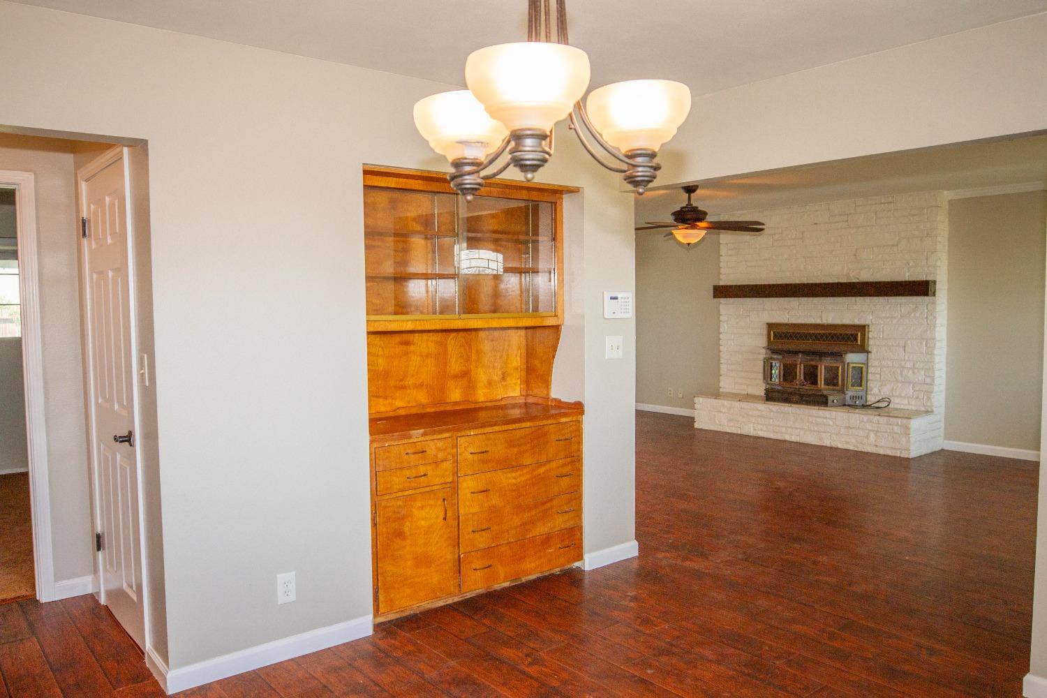 5357 South Hills Valley Road Orange Cove, CA 93646 - Photo 14 of 55 a view of a livingroom with wooden floor and a fireplace