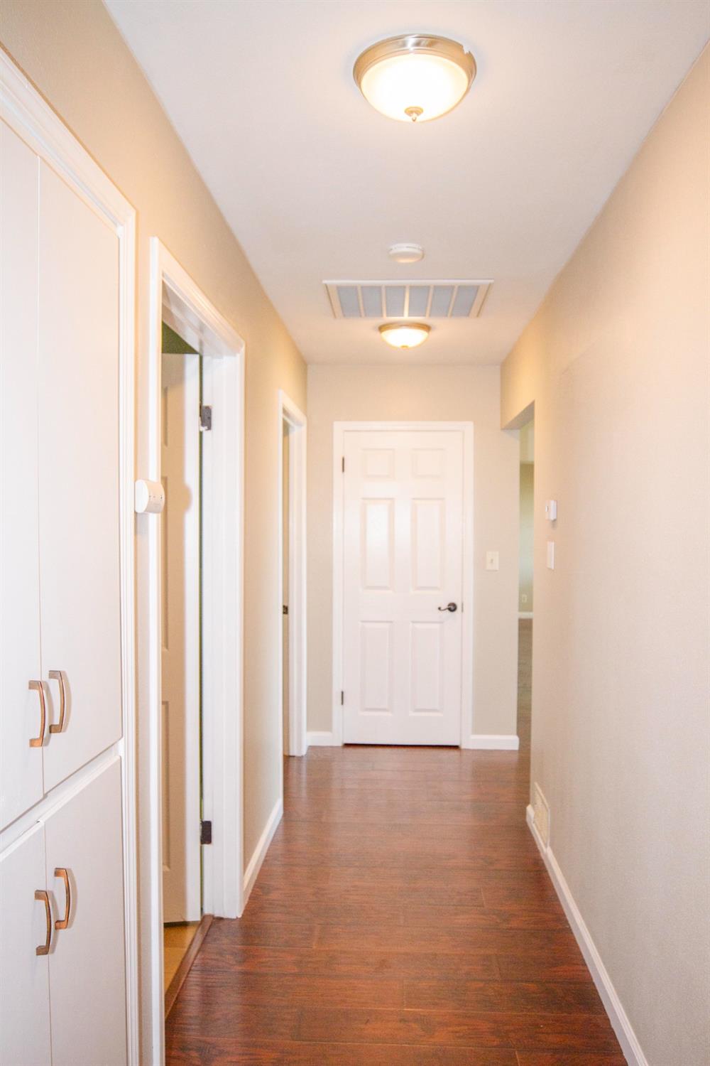 5357 South Hills Valley Road Orange Cove, CA 93646 - Photo 16 of 55 a view of a hallway with wooden floor and staircase