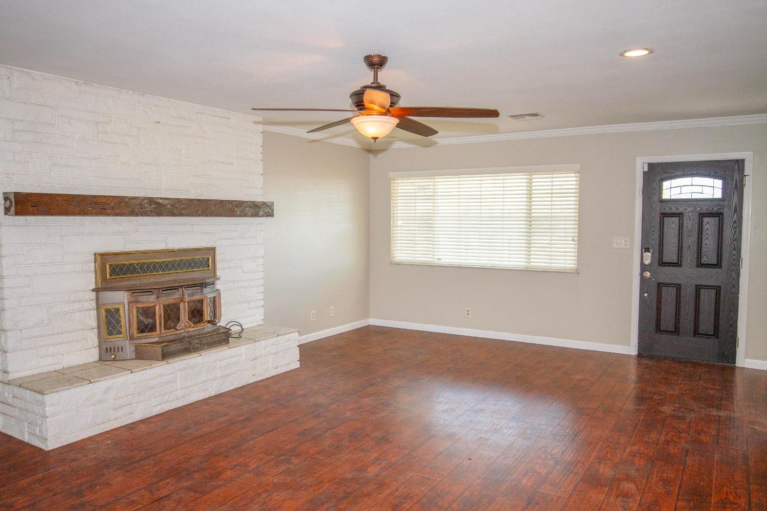 5357 South Hills Valley Road Orange Cove, CA 93646 - Photo 2 of 55 a view of an empty room with a window and fireplace