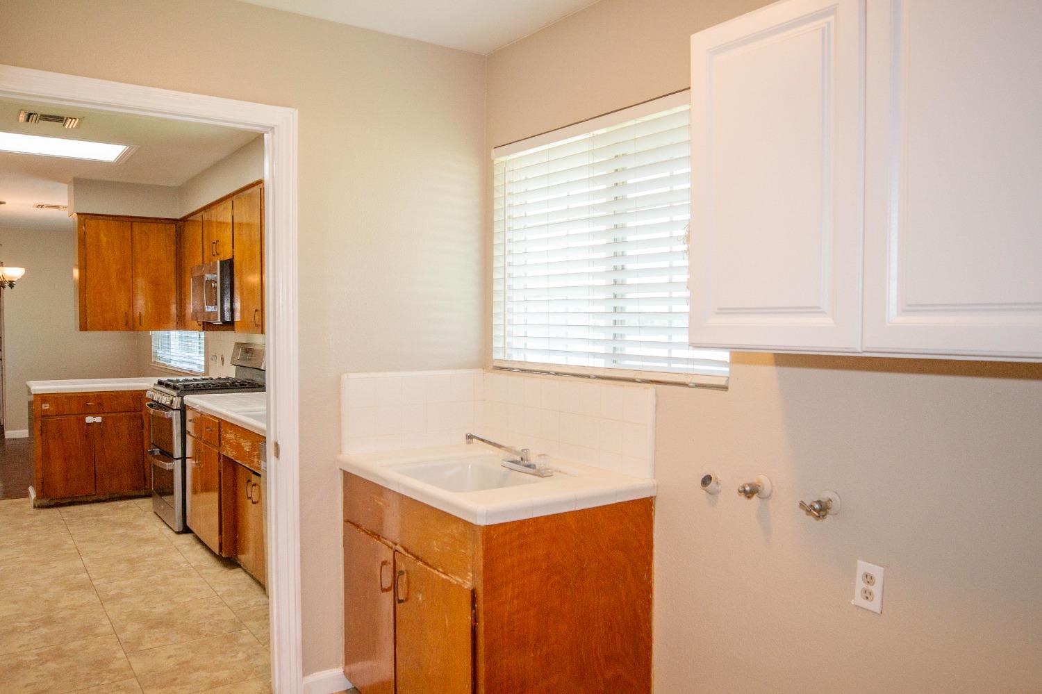 5357 South Hills Valley Road Orange Cove, CA 93646 - Photo 22 of 55 a kitchen with stainless steel appliances granite countertop a sink and a refrigerator