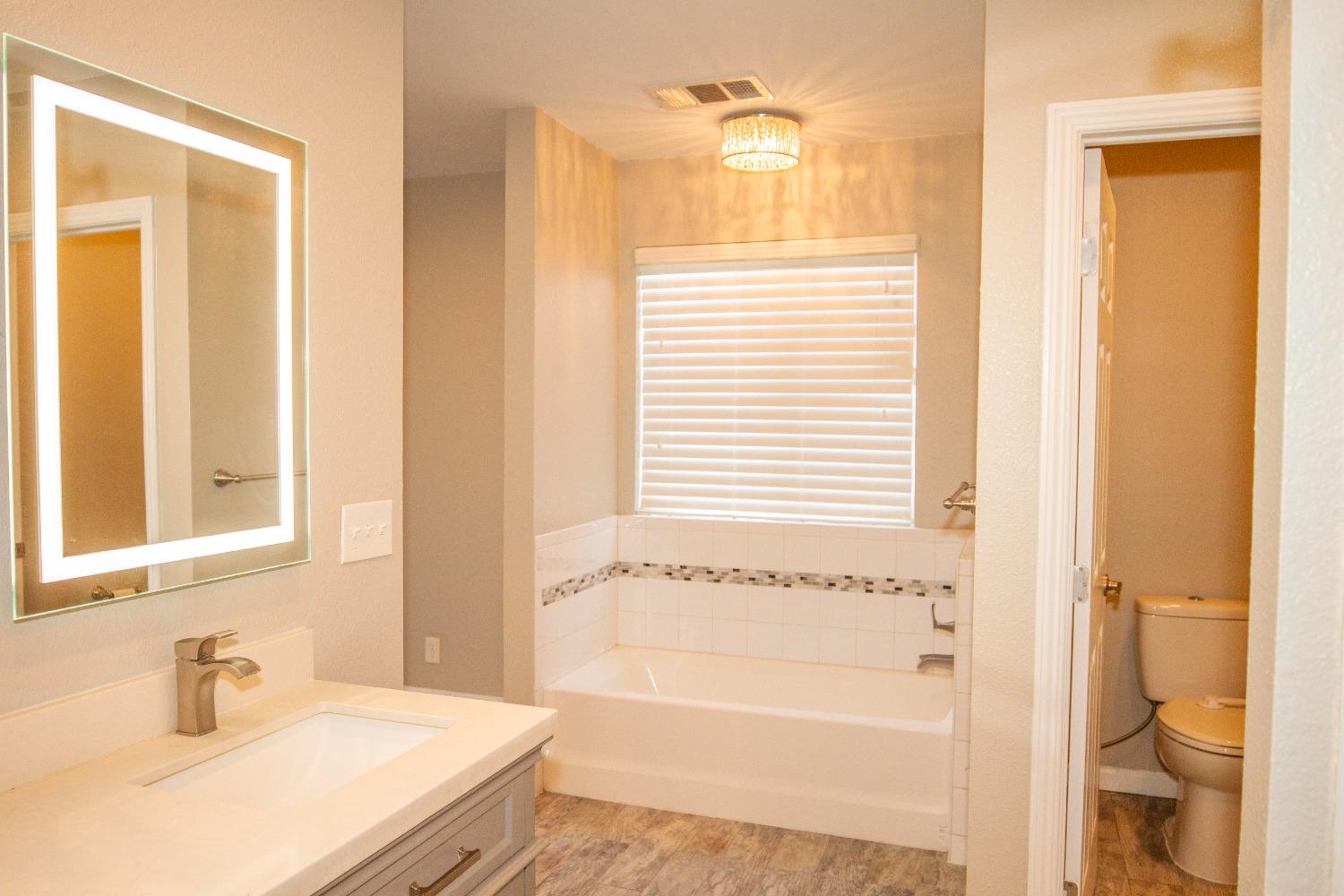 5357 South Hills Valley Road Orange Cove, CA 93646 - Photo 28 of 55 a bathroom with a bathtub and a sink