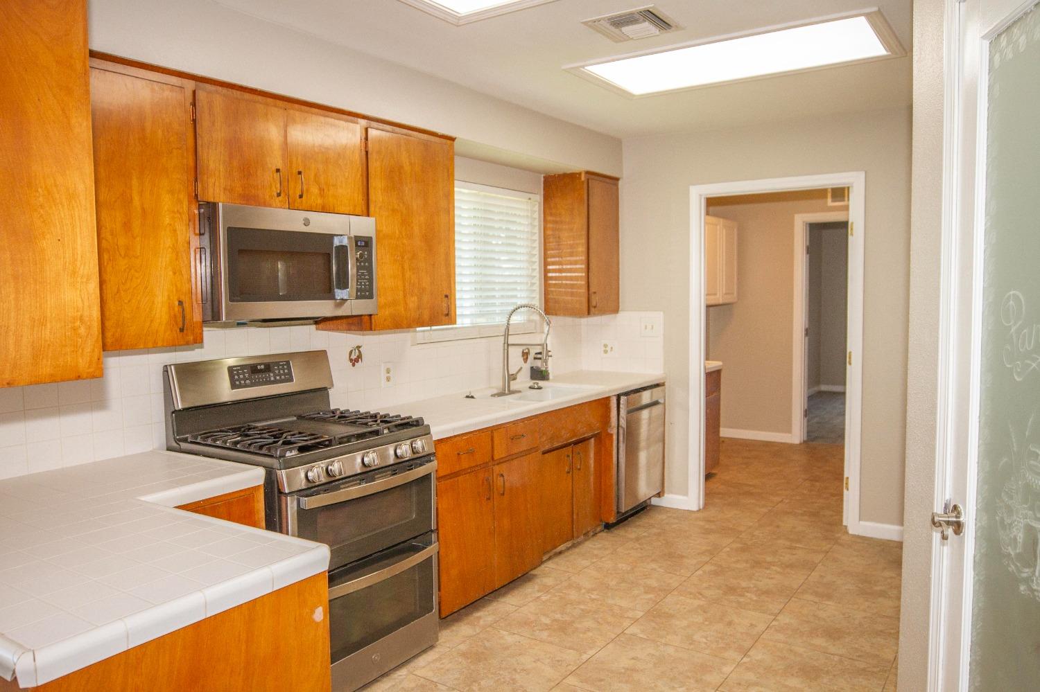 5357 South Hills Valley Road Orange Cove, CA 93646 - Photo 3 of 55 a kitchen with stainless steel appliances a stove sink and microwave