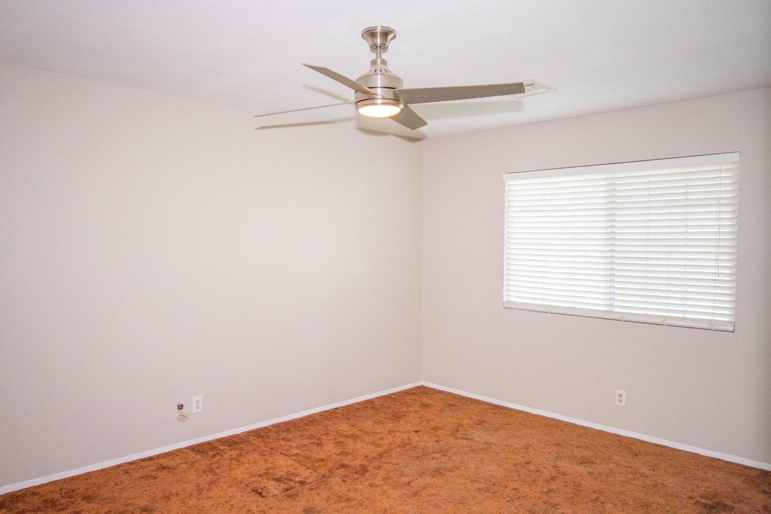 5357 South Hills Valley Road Orange Cove, CA 93646 - Photo 33 of 55 an empty room with a window and a fan
