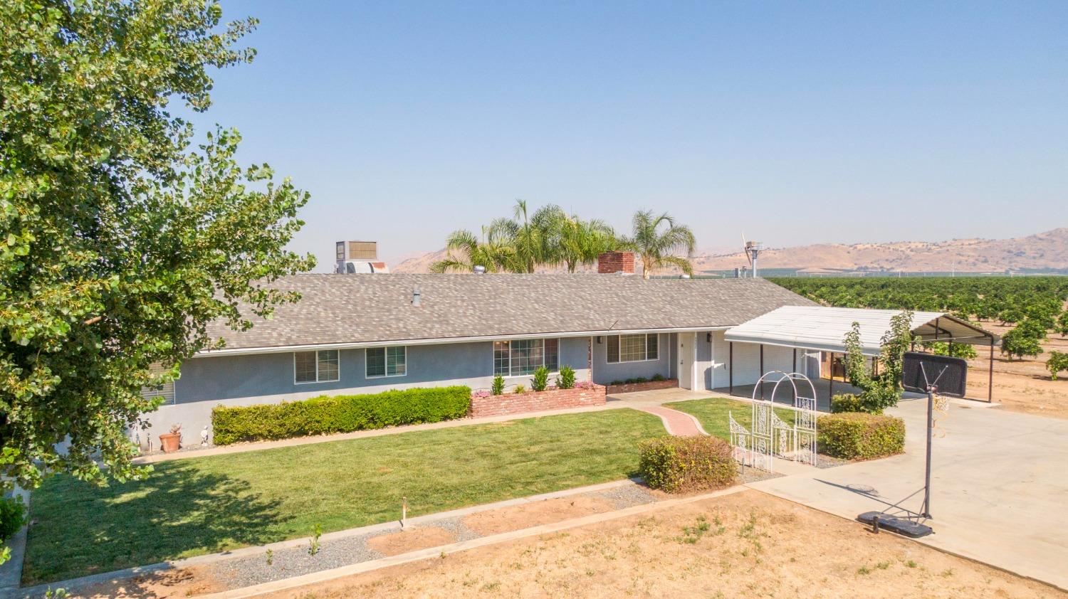 5357 South Hills Valley Road Orange Cove, CA 93646 - Photo 34 of 55 a front view of a house with a yard