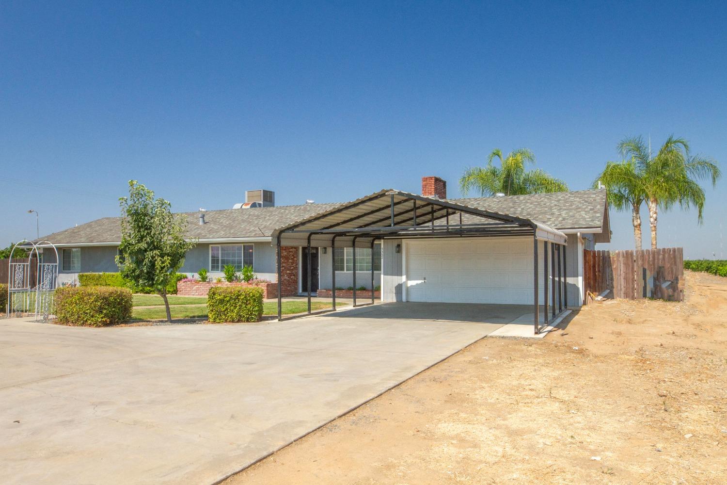 5357 South Hills Valley Road Orange Cove, CA 93646 - Photo 36 of 55 a front view of a house with a yard and potted plants