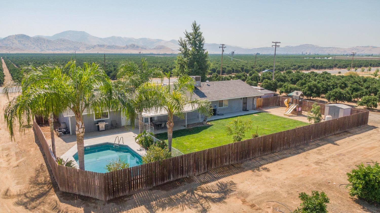 5357 South Hills Valley Road Orange Cove, CA 93646 - Photo 40 of 55 a view of a house with pool and a yard