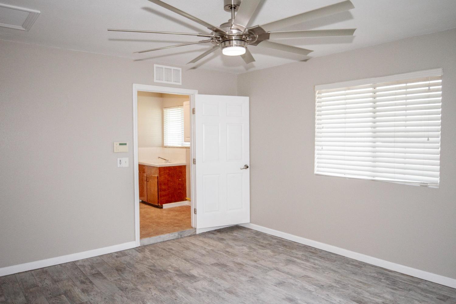 5357 South Hills Valley Road Orange Cove, CA 93646 - Photo 4 of 55 an empty room with fan and windows
