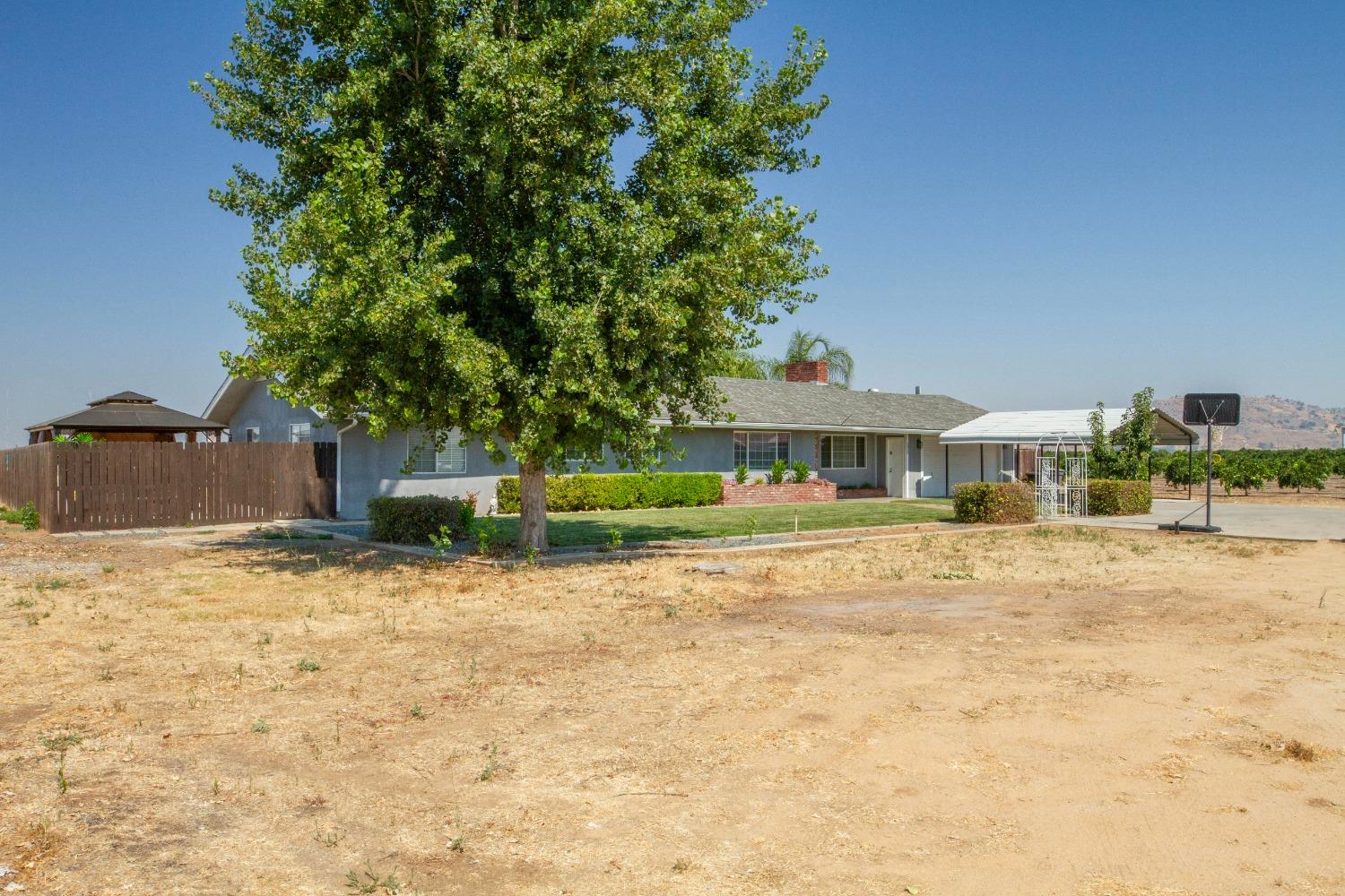 5357 South Hills Valley Road Orange Cove, CA 93646 - Photo 41 of 55 a front view of a house with a yard