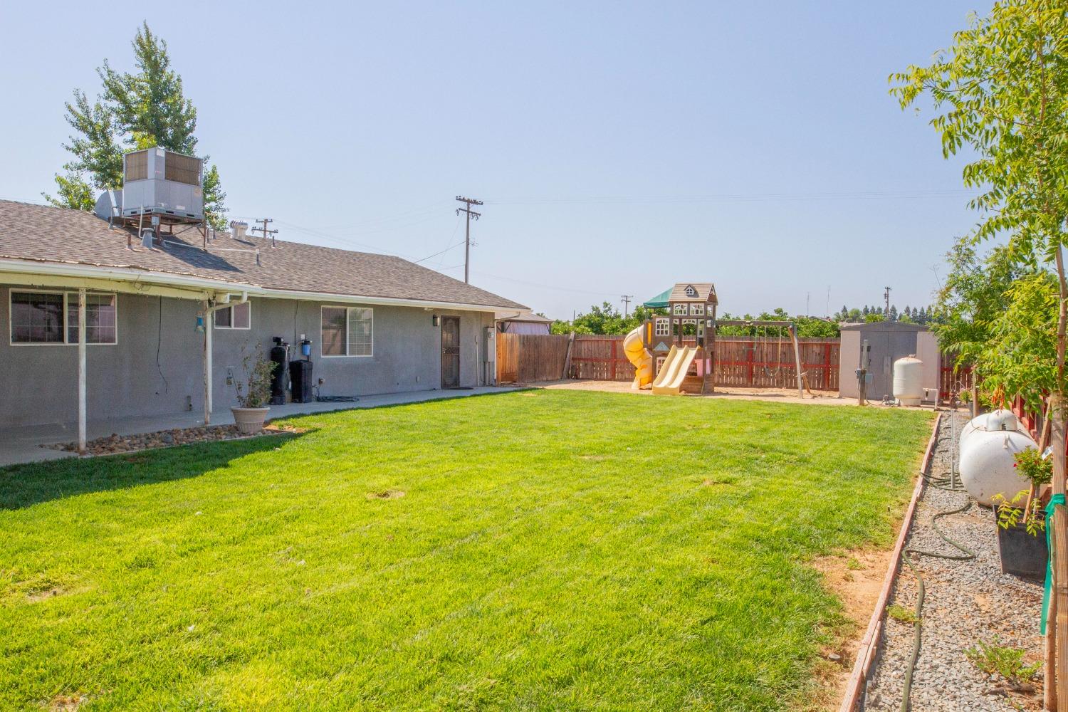 5357 South Hills Valley Road Orange Cove, CA 93646 - Photo 43 of 55 a front view of a house with garden