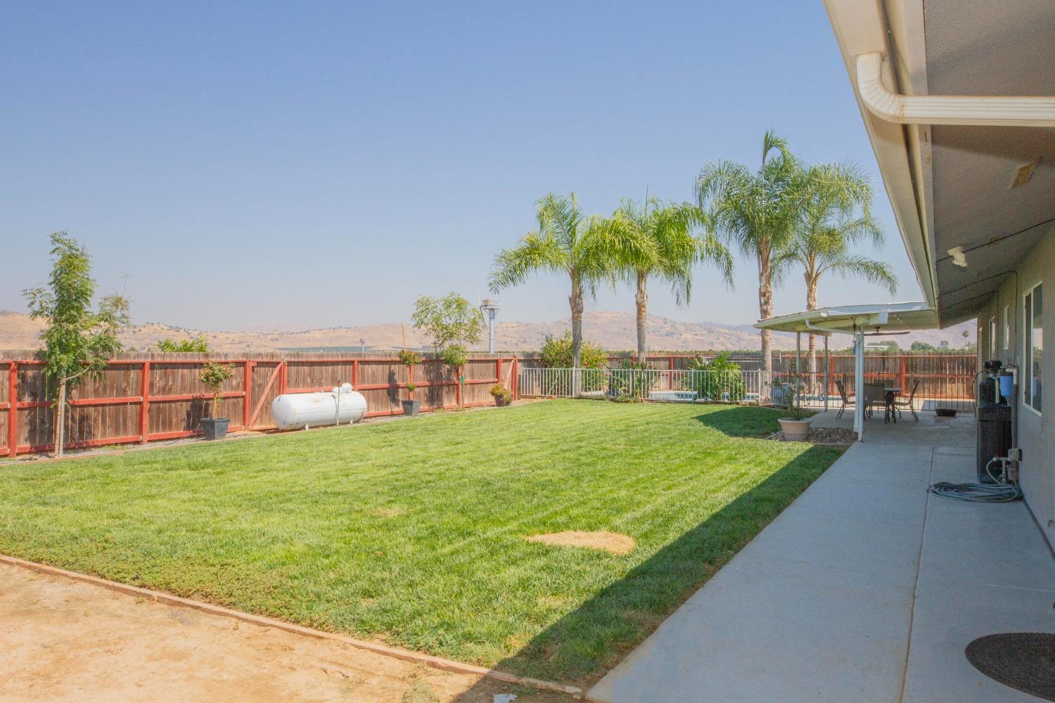5357 South Hills Valley Road Orange Cove, CA 93646 - Photo 44 of 55 a view of a backyard with a garden and plants