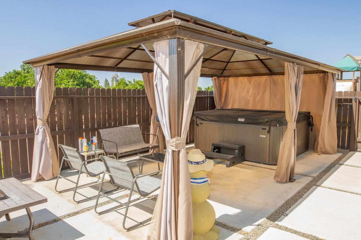 5357 South Hills Valley Road Orange Cove, CA 93646 - Photo 49 of 55 a view of a patio with table and chairs under an umbrella