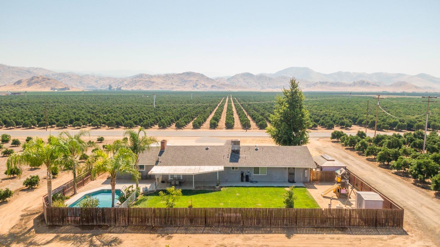 5357 South Hills Valley Road Orange Cove, CA 93646 - Photo 7 of 55 a view of a house with pool and a yard