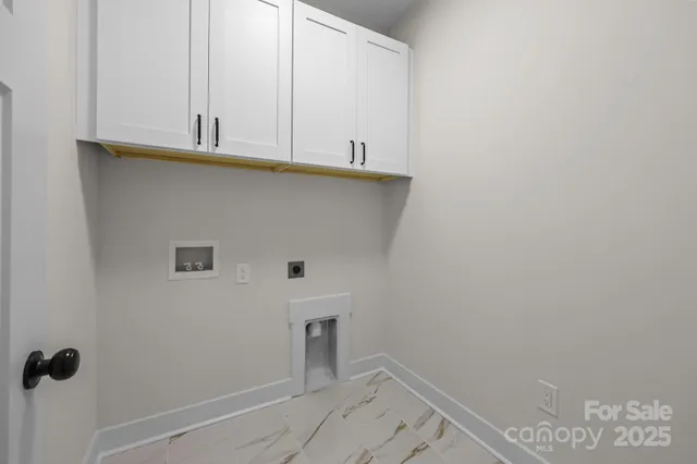 a view of a kitchen with white cabinets