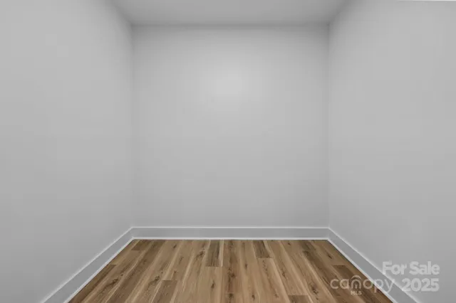 a view of wooden floor in a small bathroom