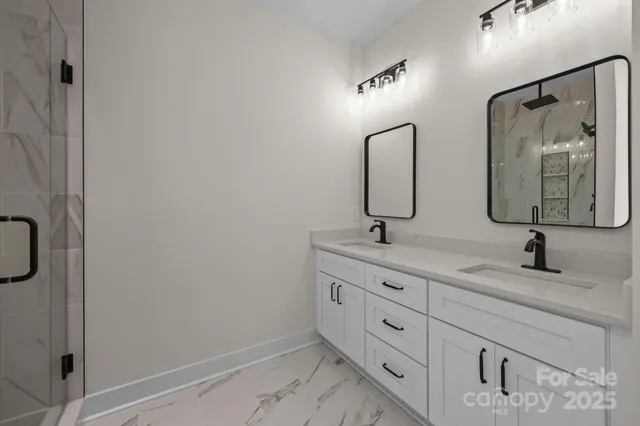 a bathroom with a double vanity sink and mirror