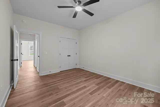 a view of an empty room and wooden floor