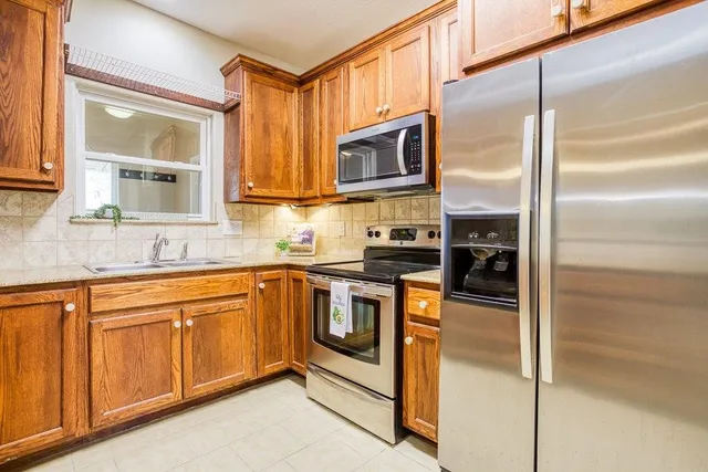 a view of a refrigerator and cabinets