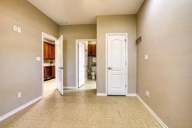a bathroom with a granite countertop sink a toilet a mirror and shower