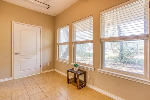 a view of a room with a lounge chair and windows