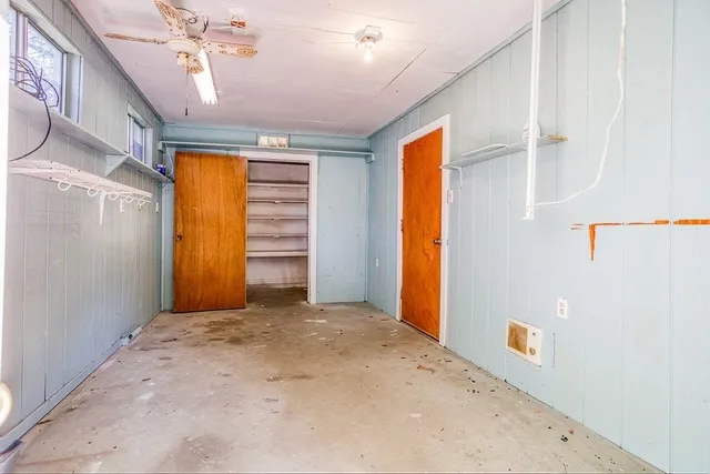a view of a room with wooden walls