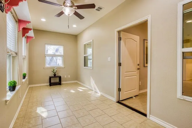 an empty room with windows and entrance