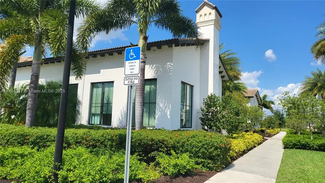 a view of a house with a yard and potted plants
