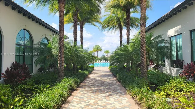 a view of a pathway of a house with a yard
