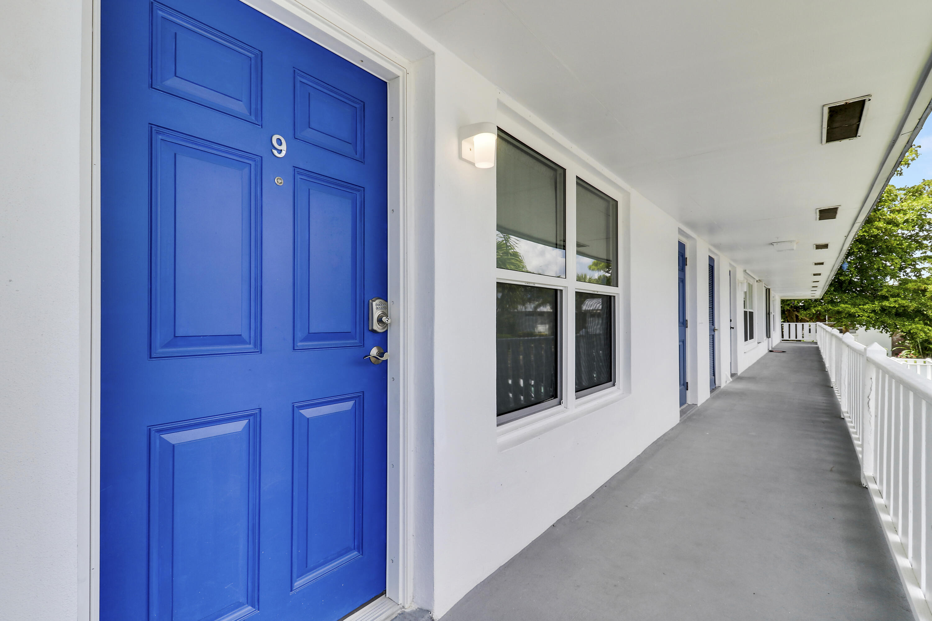 2929 Southeast Ocean Boulevard, Unit I9 Stuart, FL 34996 - Photo 3 of 19 a view of a hallway with wooden walls and stairs