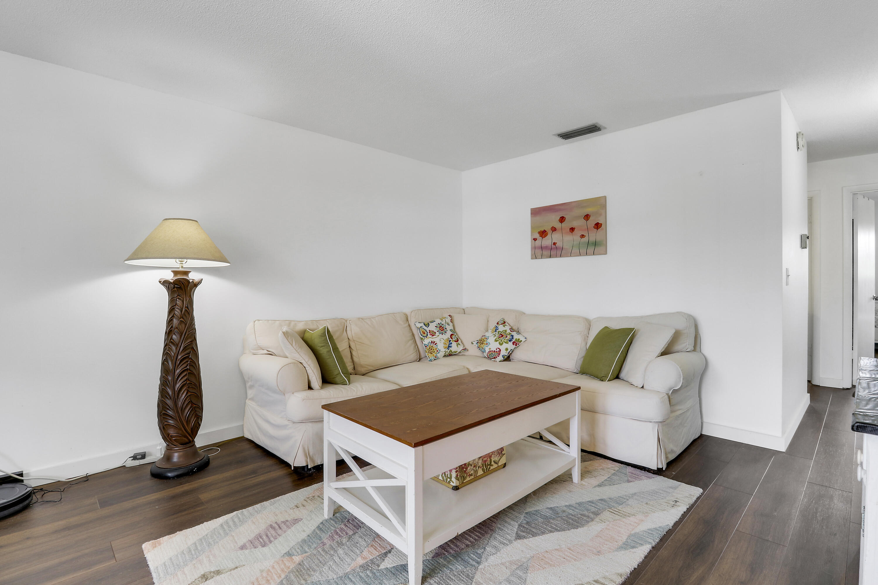2929 Southeast Ocean Boulevard, Unit I9 Stuart, FL 34996 - Photo 6 of 19 a living room with furniture and a table