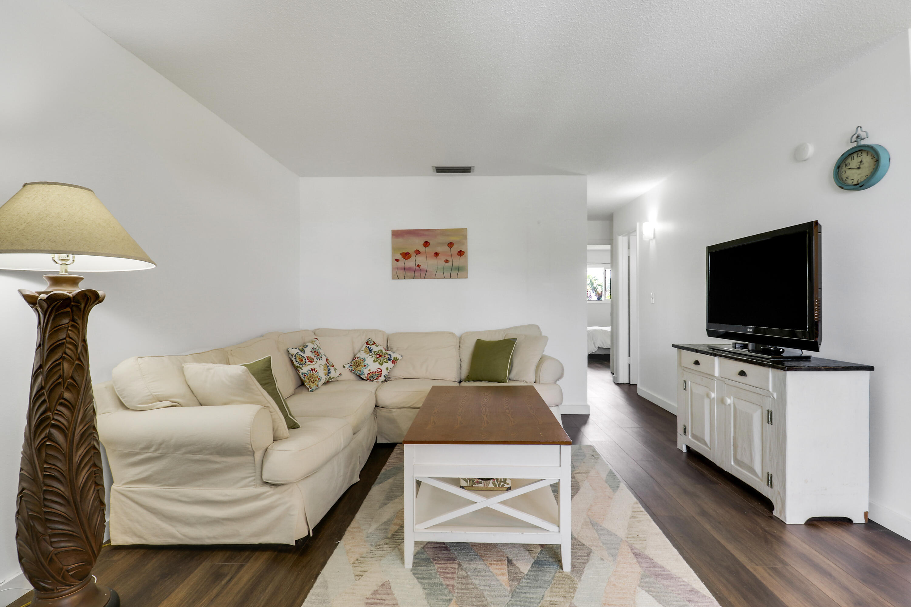 2929 Southeast Ocean Boulevard, Unit I9 Stuart, FL 34996 - Photo 7 of 19 a living room with furniture and a flat screen tv