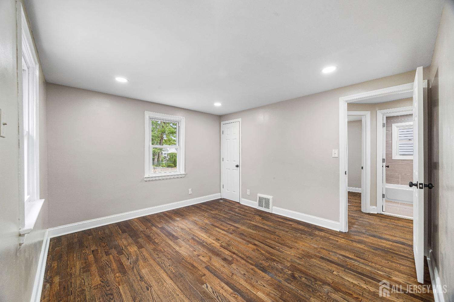 92 Highfield Road Colonia, NJ 07067 - Photo 11 of 25 a view of empty room with wooden floor and fan