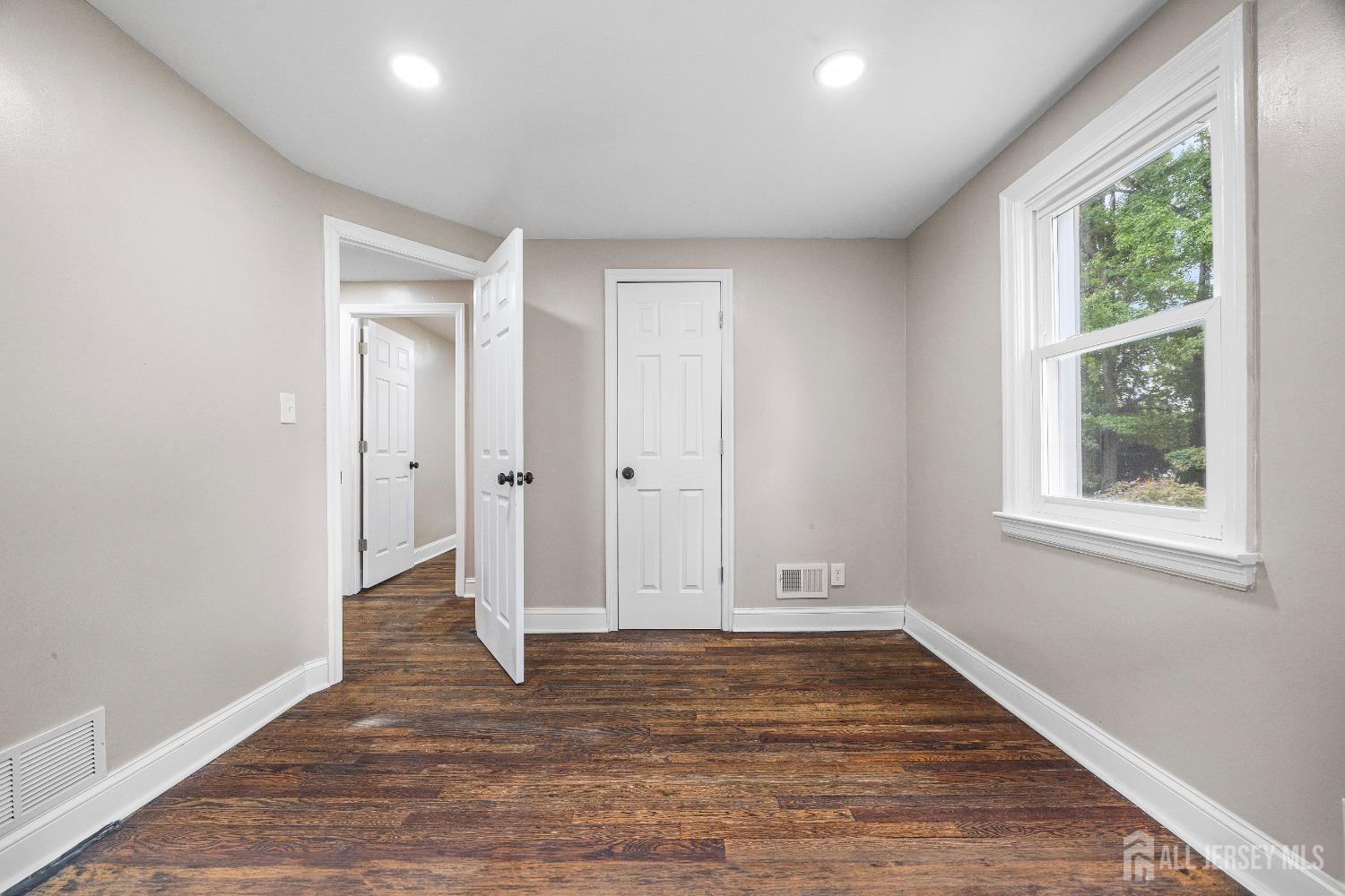 92 Highfield Road Colonia, NJ 07067 - Photo 14 of 25 a view of an empty room with wooden floor and a window