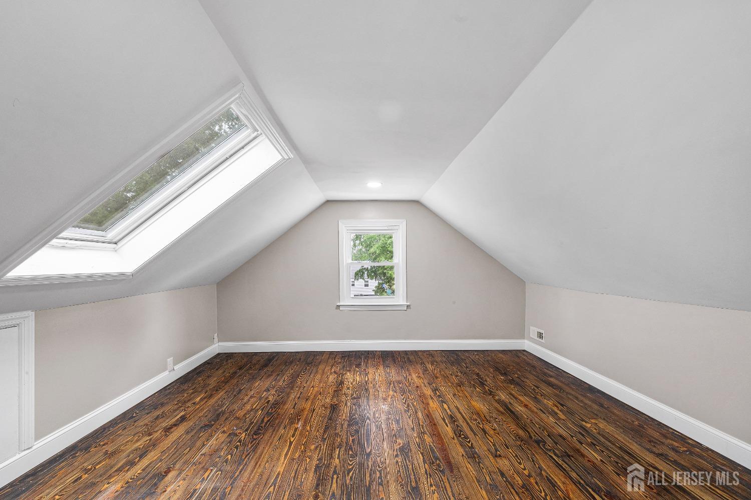 92 Highfield Road Colonia, NJ 07067 - Photo 22 of 25 an empty room with wooden floor and window
