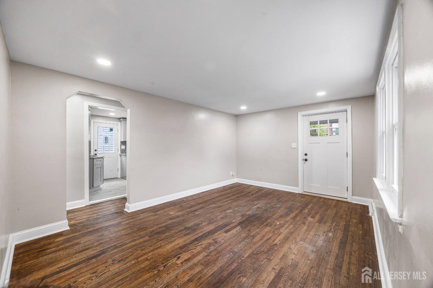 92 Highfield Road Colonia, NJ 07067 - Photo 6 of 25 wooden floor in an empty room with a window