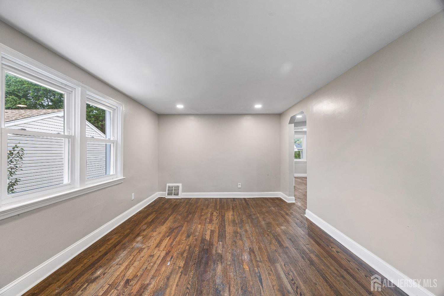 92 Highfield Road Colonia, NJ 07067 - Photo 7 of 25 a view of empty room with wooden floor and fan