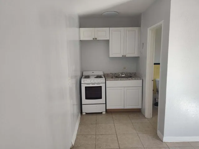 a utility room with sink dryer and washer