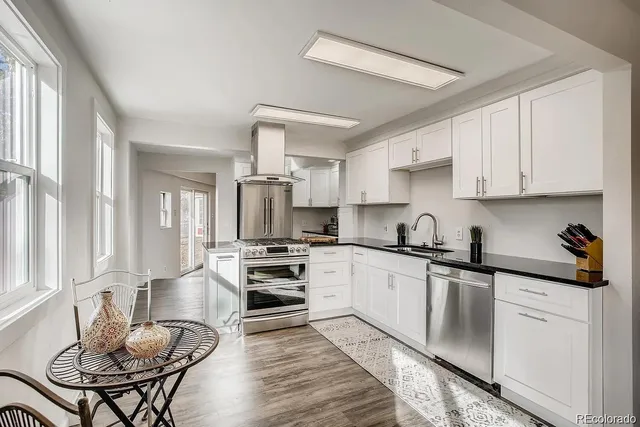 a kitchen with stainless steel appliances kitchen island granite countertop a sink and cabinets